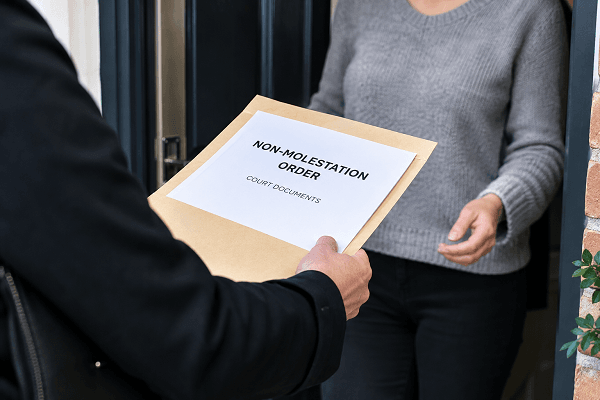 man handing over non molestation order